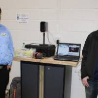 Two seniors standing in front of their projects